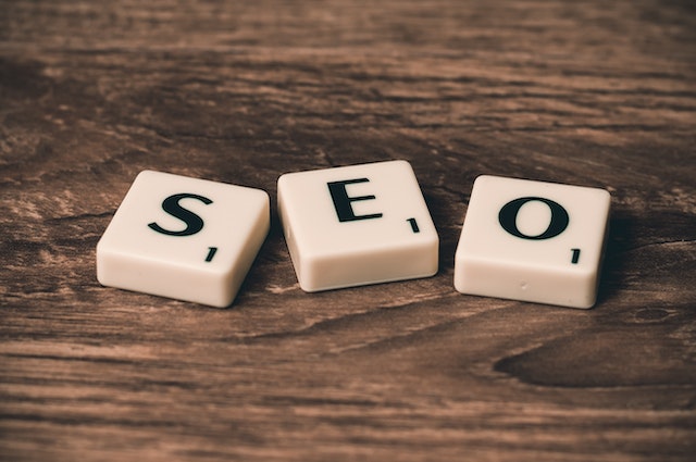 A white dices that spell out the word SEO which is a method to increase website traffic