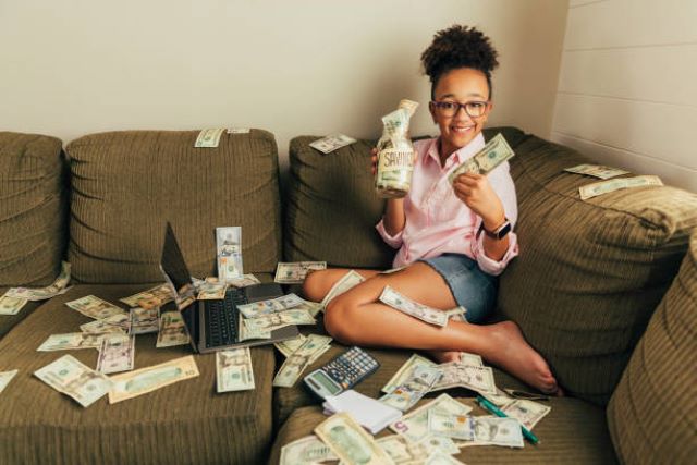 A photo showing making money sitting on the couch