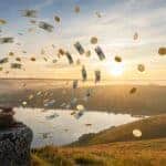 Meditation abundance visualization with money flying around woman at sunrise